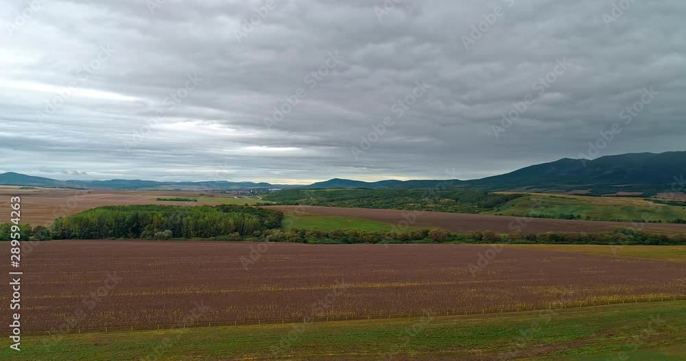 Drone view of the North Hungarian landscape of the Muzsla, part of Matra. Hills and fields of agricultural view with roads in the distance view. Cloudy view after rain with fog in the forest. Drone view of the North Hungarian landscape of the Muzsla, part of Matra. Hills and fields of agricultural view with roads in the distance view. Cloudy view after rain with fog in the forest.