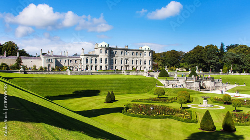 Tourists visiting Powerscourt Gardens one of the most beautiful gardens in Ireland view on mansion from terraced lawn