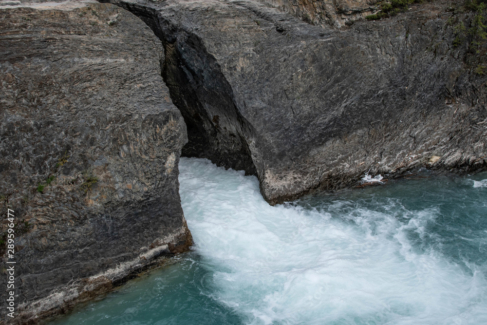 Water flowing between cracked rocks
