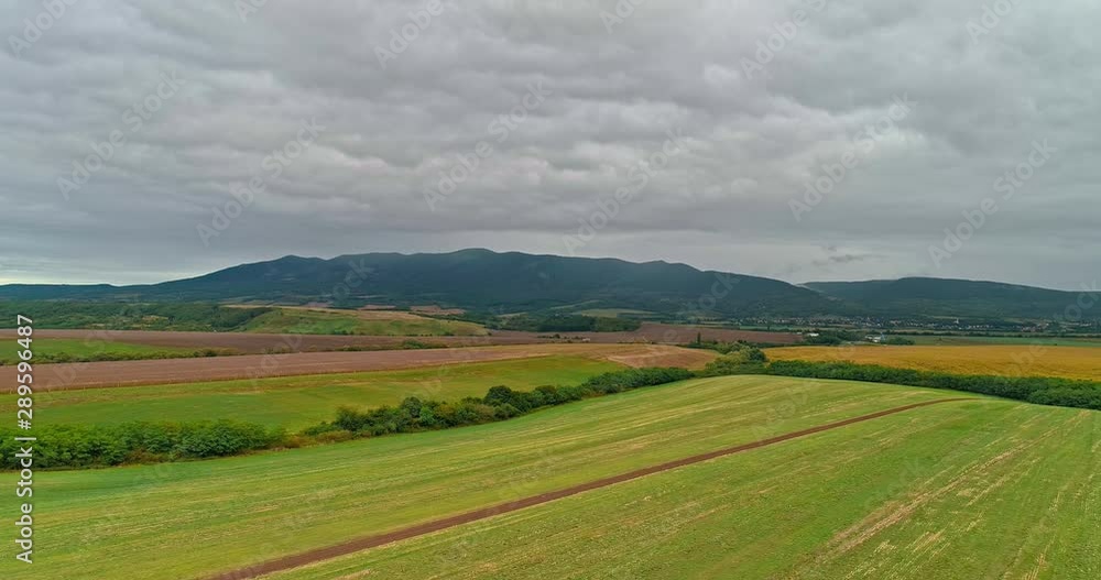 Drone view of the North Hungarian landscape of the Muzsla, part of Matra. Hills and fields of agricultural view with roads in the distance view. Cloudy view after rain with fog in the forest. Drone view of the North Hungarian landscape of the Muzsla, part of Matra. Hills and fields of agricultural view with roads in the distance view. Cloudy view after rain with fog in the forest.