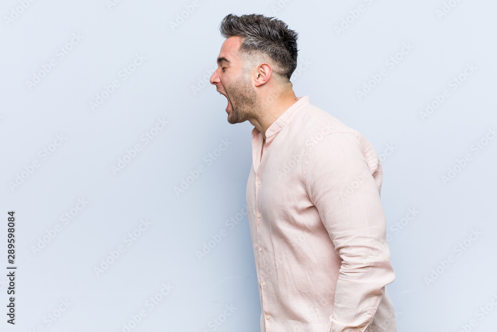 Young handsome cool man shouting towards a copy space Young handsome cool man shouting towards a copy space