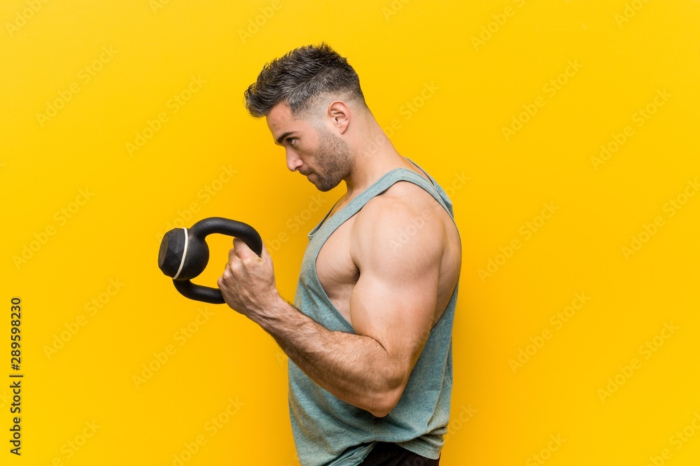 Caucasian trainer man with a dumbbell