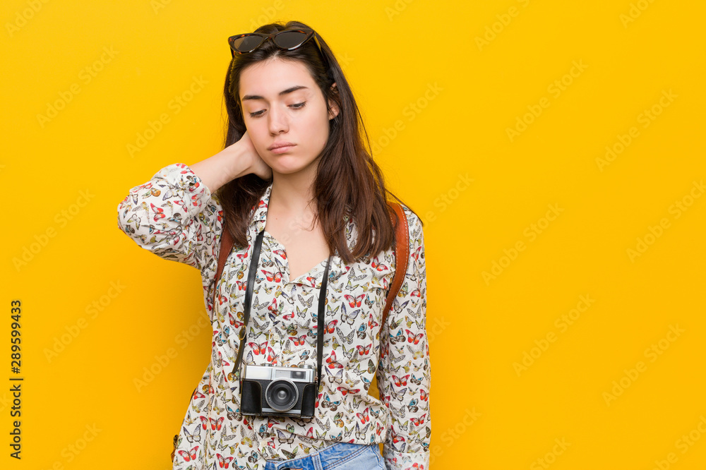 Young brunette traveler woman suffering neck pain due to sedentary lifestyle. Young brunette traveler woman suffering neck pain due to sedentary lifestyle.