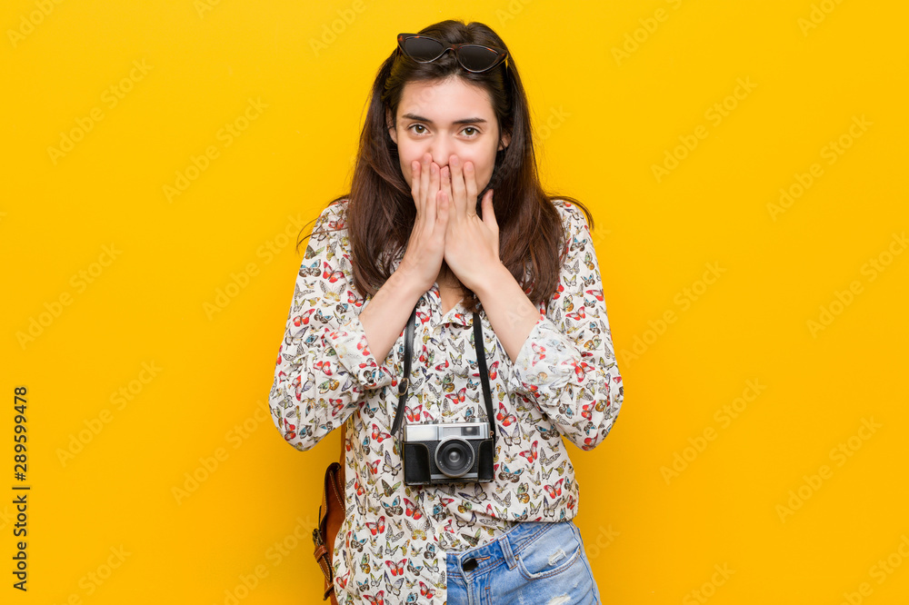 Young brunette traveler woman laughing about something, covering mouth with hands. Young brunette traveler woman laughing about something, covering mouth with hands.
