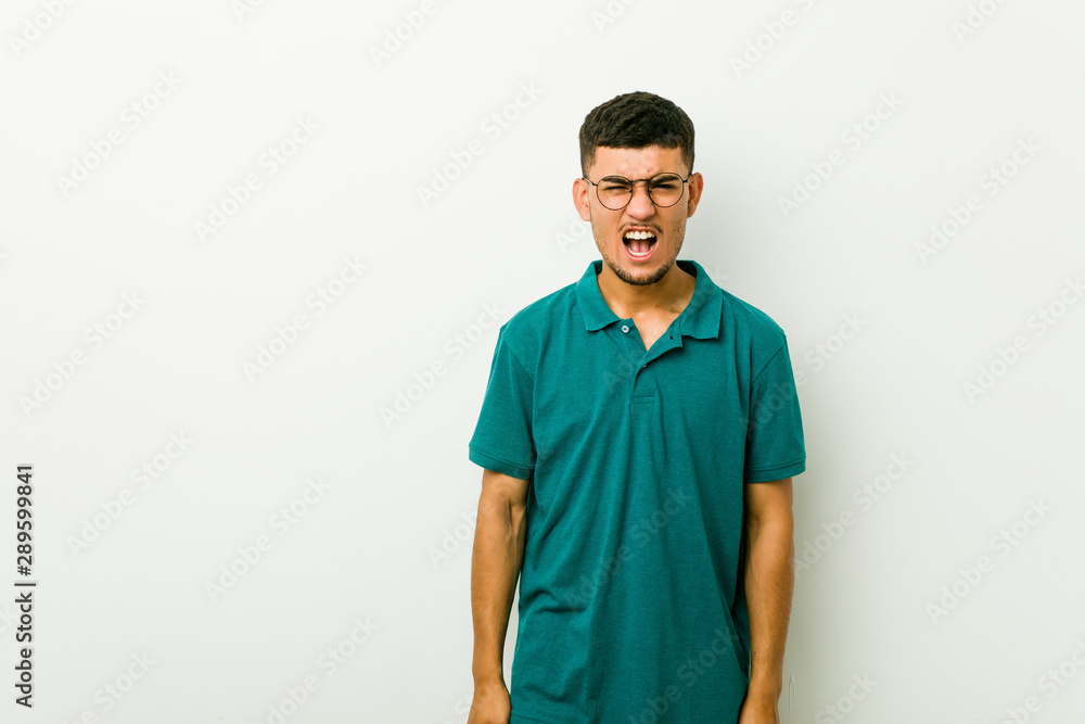Fototapeta premium Young hispanic man screaming very angry and aggressive.