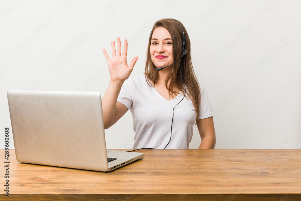 Young telemarketer woman smiling cheerful showing number five with fingers. Young telemarketer woman smiling cheerful showing number five with fingers.
