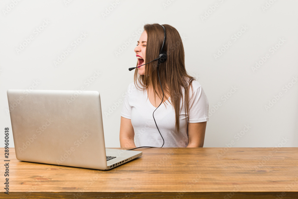Young telemarketer woman shouting towards a copy space Young telemarketer woman shouting towards a copy space