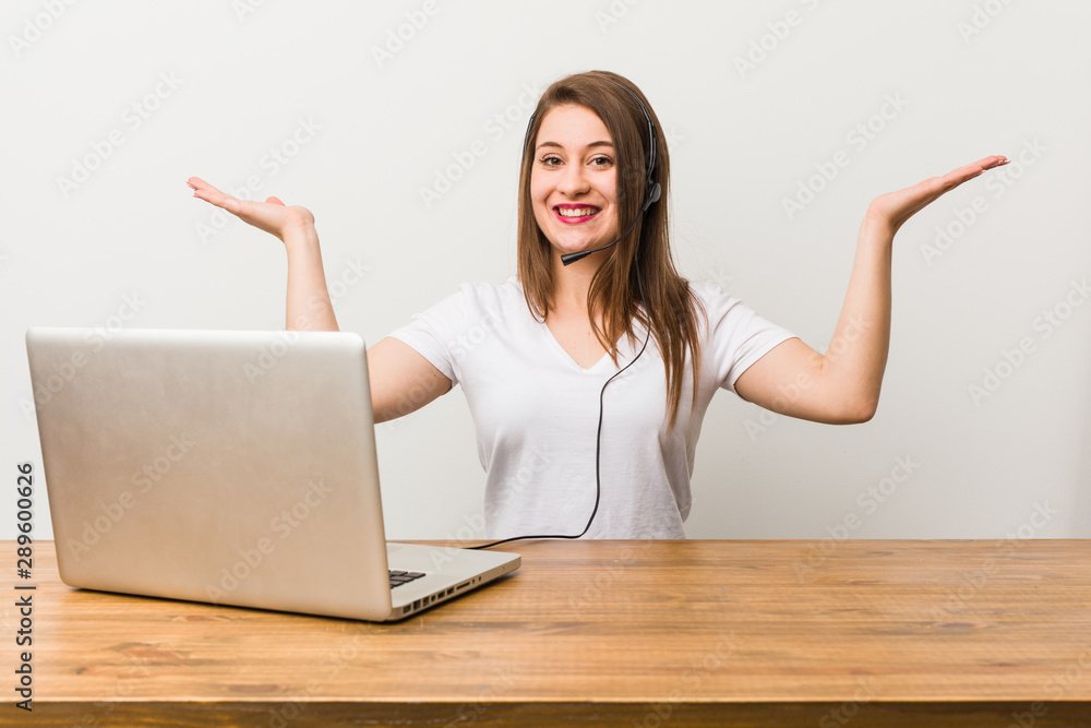 Young telemarketer woman makes scale with arms, feels happy and confident.
