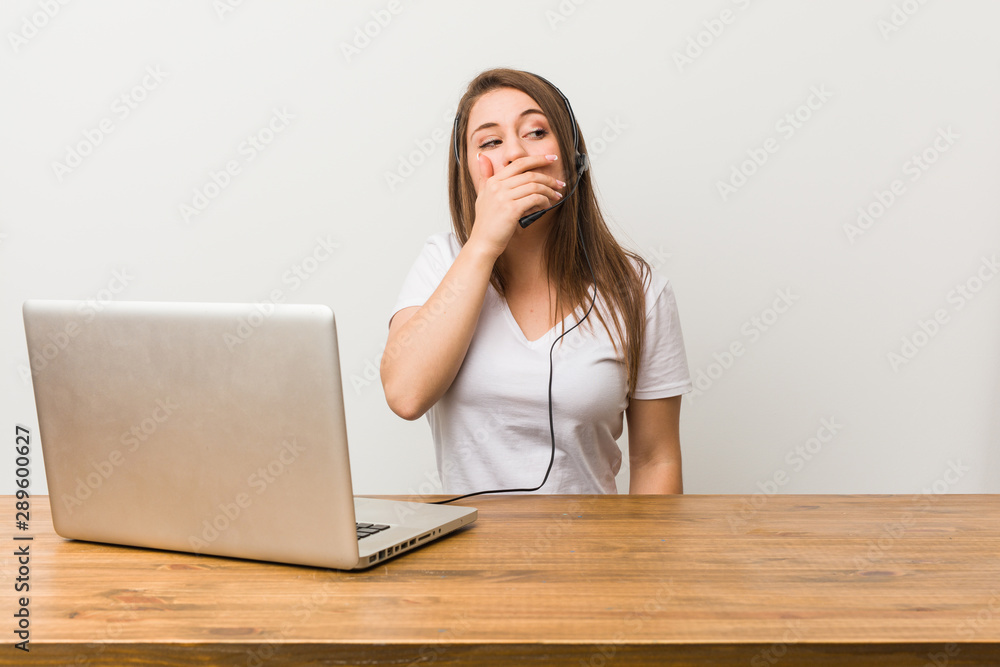 Young telemarketer woman thoughtful looking to a copy space covering mouth with hand. Young telemarketer woman thoughtful looking to a copy space covering mouth with hand.