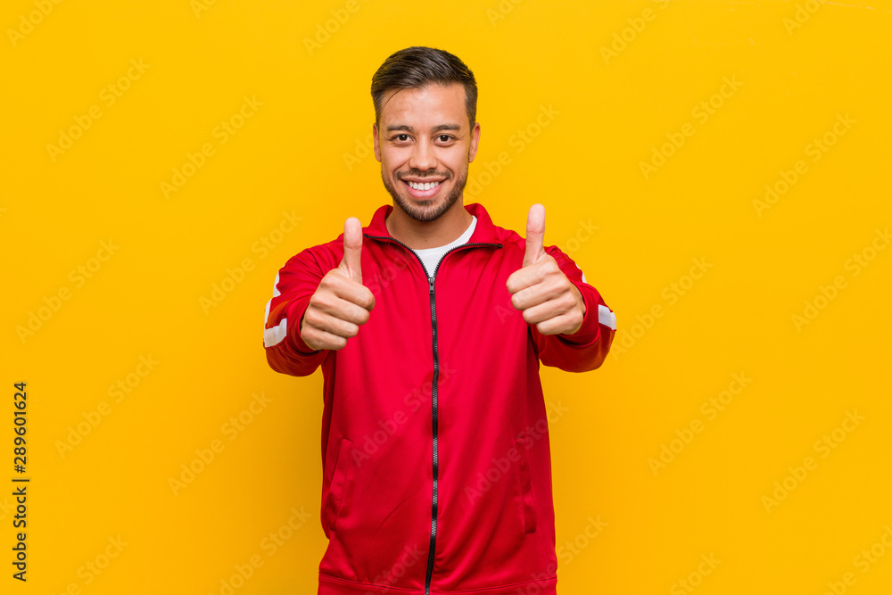 Young filipino fitness man with thumbs ups, cheers about something, support and respect concept. Young filipino fitness man with thumbs ups, cheers about something, support and respect concept.