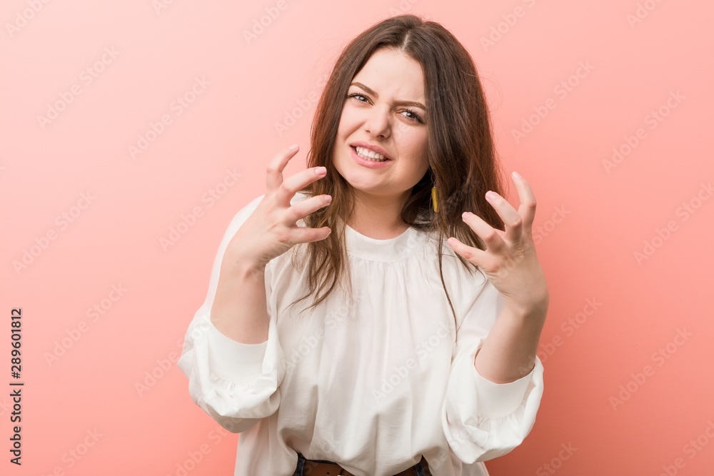 Young caucasian curvy woman standing against pink background Young caucasian curvy woman standing against pink background