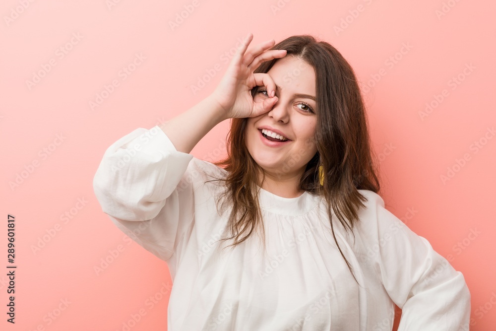 Young caucasian curvy woman standing against pink background Young caucasian curvy woman standing against pink background