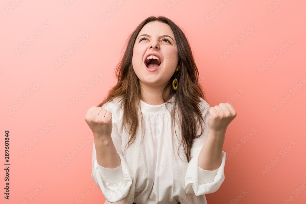 Young caucasian curvy woman standing against pink background Young caucasian curvy woman standing against pink background