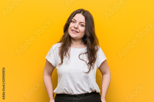 Young curvy plus size woman happy, smiling and cheerful.
