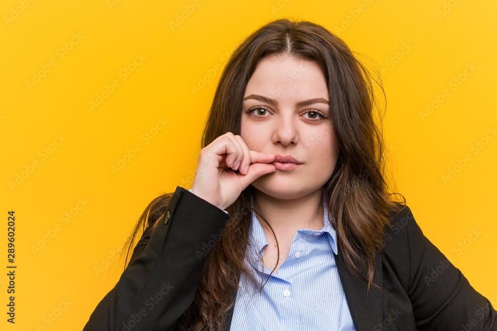 Young plus size caucasian business woman with fingers on lips keeping a secret. Young plus size caucasian business woman with fingers on lips keeping a secret.
