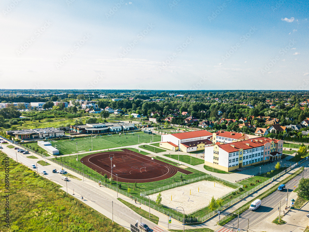 Aerial view of a high school and its stadium in Poland, Warsaw. Drone photo. 