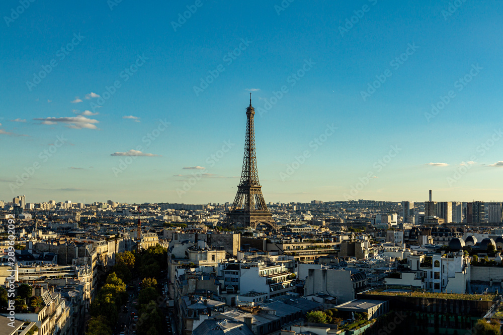 Panoramic view of Paris with the Eiffel Tower in the center of the panorama. Eiffel Tower on the background of Paris buildings.