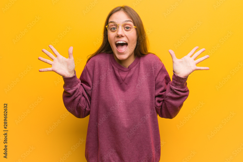 Young casual woman celebrating a victory or success Young casual woman celebrating a victory or success