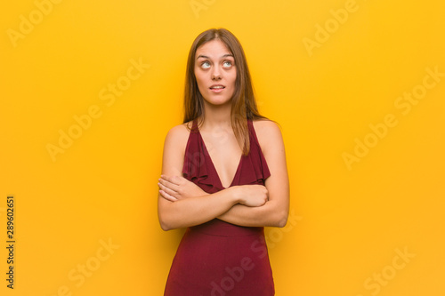 Young elegant woman wearing a dress tired and bored