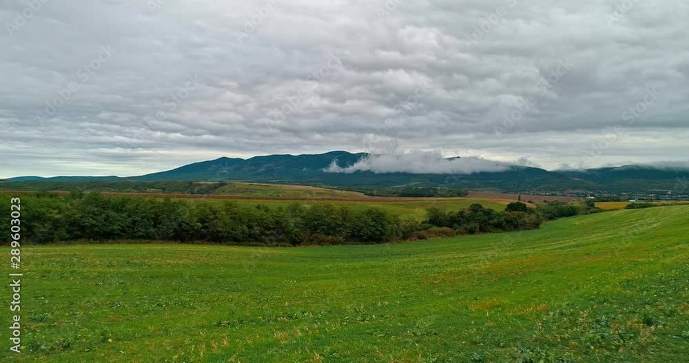 Drone view of the North Hungarian landscape of the Muzsla, part of Matra. Hills and fields of agricultural view with roads in the distance view. Cloudy view after rain with fog in the forest. Drone view of the North Hungarian landscape of the Muzsla, part of Matra. Hills and fields of agricultural view with roads in the distance view. Cloudy view after rain with fog in the forest.