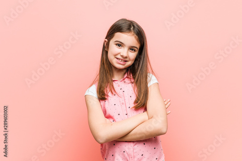 Cute little girl who feels confident, crossing arms with determination.