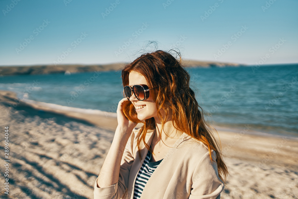 woman with mobile phone on the beach