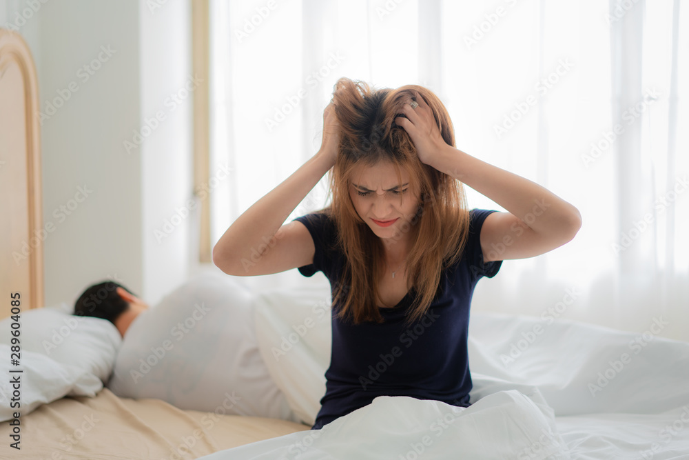 Unhappy couple not talking after an argument in bed at home. People, relationship difficulties and family concept Unhappy couple not talking after an argument in bed at home. People, relationship difficulties and family concept