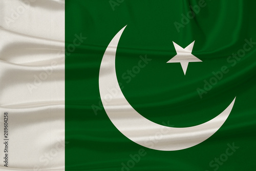 beautiful photo of the national flag of Pakistan on delicate shiny silk with soft draperies, the concept of state power, country life, horizontal, close-up, copy space