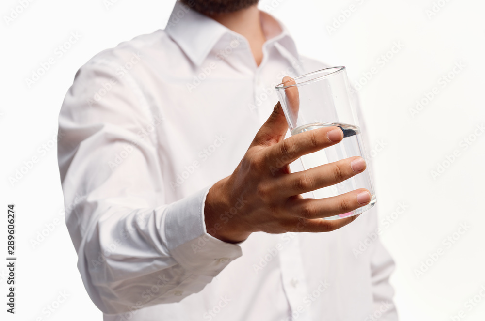 man holding a glass of water man holding a glass of water