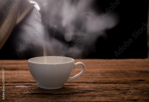 cup of hot coffee on wooden table