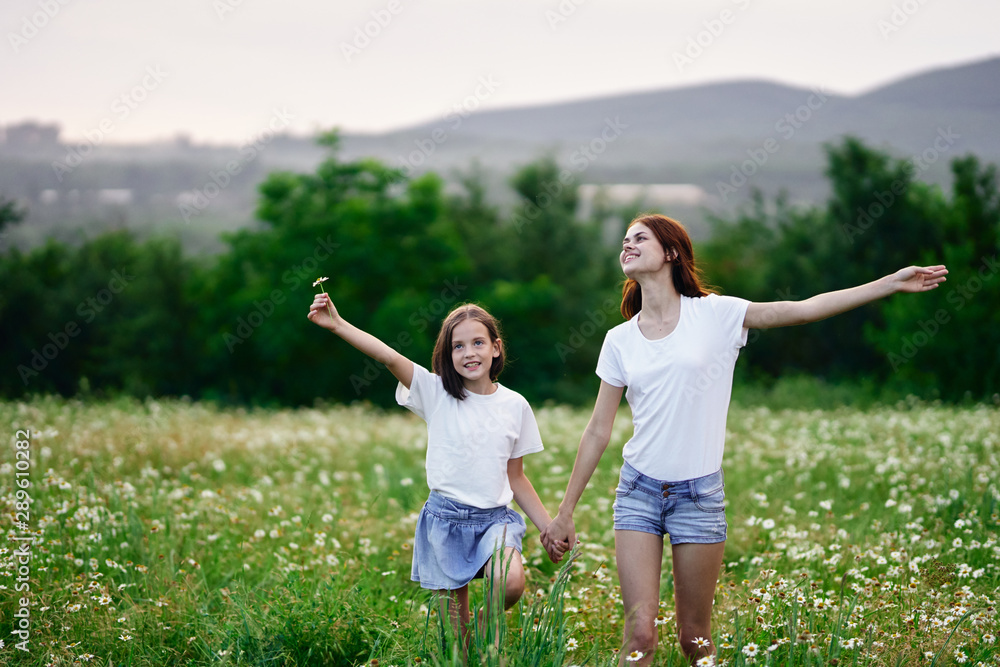 Fototapeta premium mother and daughter having fun in the field