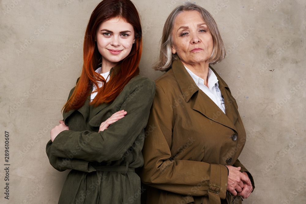 two businesswomen with folded arms crossed two businesswomen with folded arms crossed