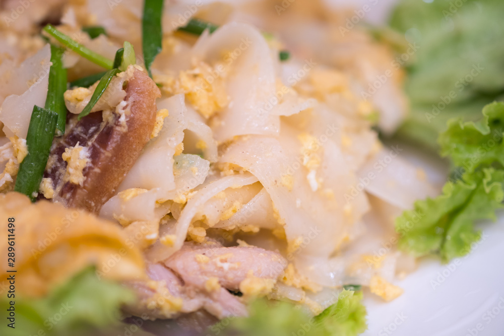 Chinese-Thai dish made with stir-fried rice noodles mixed with chicken Chinese-Thai dish made with stir-fried rice noodles mixed with chicken