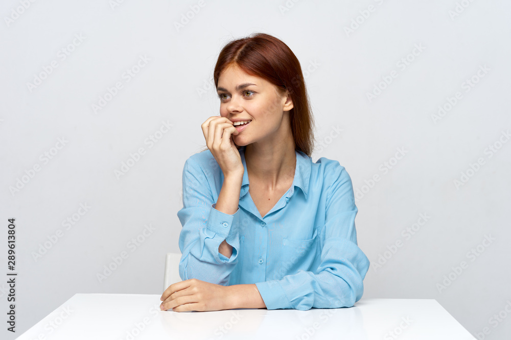 portrait of a young woman sitting at desk portrait of a young woman sitting at desk