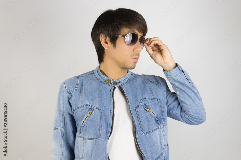 Young Asian Man in Jeans or Denim Jacket Touch Sunglasses Looking Right Frame Young Asian Man in Jeans or Denim Jacket Touch Sunglasses Looking Right Frame