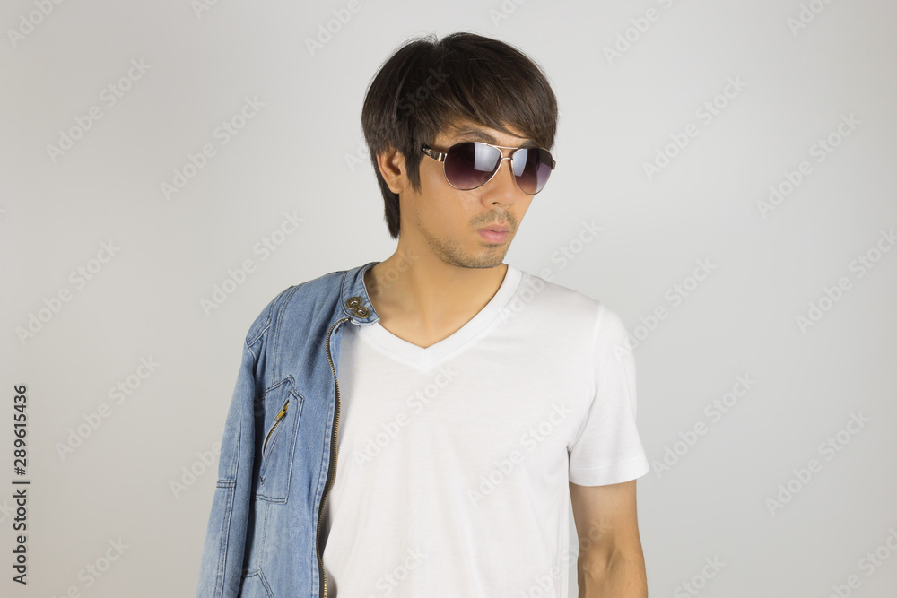 Young Asian Man in Jeans or Denim Jacket Wear Sunglasses and Show T-Shirt Young Asian Man in Jeans or Denim Jacket Wear Sunglasses and Show T-Shirt