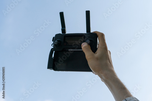 person holding a wireless gadget remote control with joystick and antennas