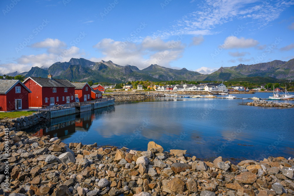 Red hut with a blue sky reflecting the water at Kabelvaag In the Lofoten Islands, northern Norway.