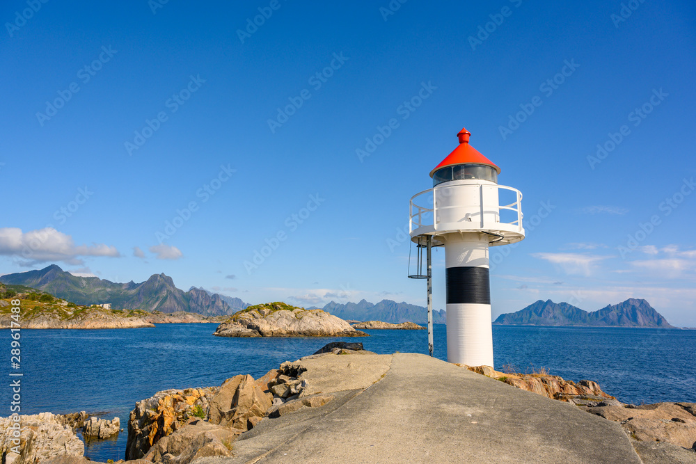 White lighthouse by the sea during the day, clear sky at Kabelvaag In the Lofoten Islands, northern Norway.