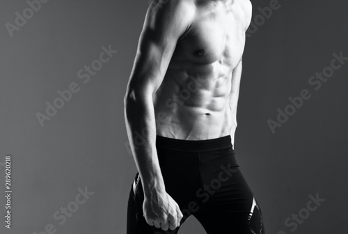 muscular man posing on black background © SHOTPRIME STUDIO