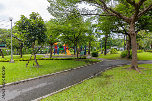 View of city park with exercise path surrounded by nature.