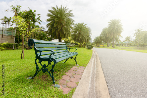 View of city park with exercise path surrounded by nature.