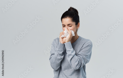 woman blowing her nose photo