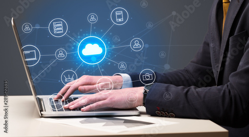 Businessman hand typing with cloud technology system and office symbol concept