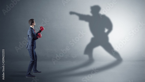 Businessman fighting with his strong karate man shadow © ra2 studio