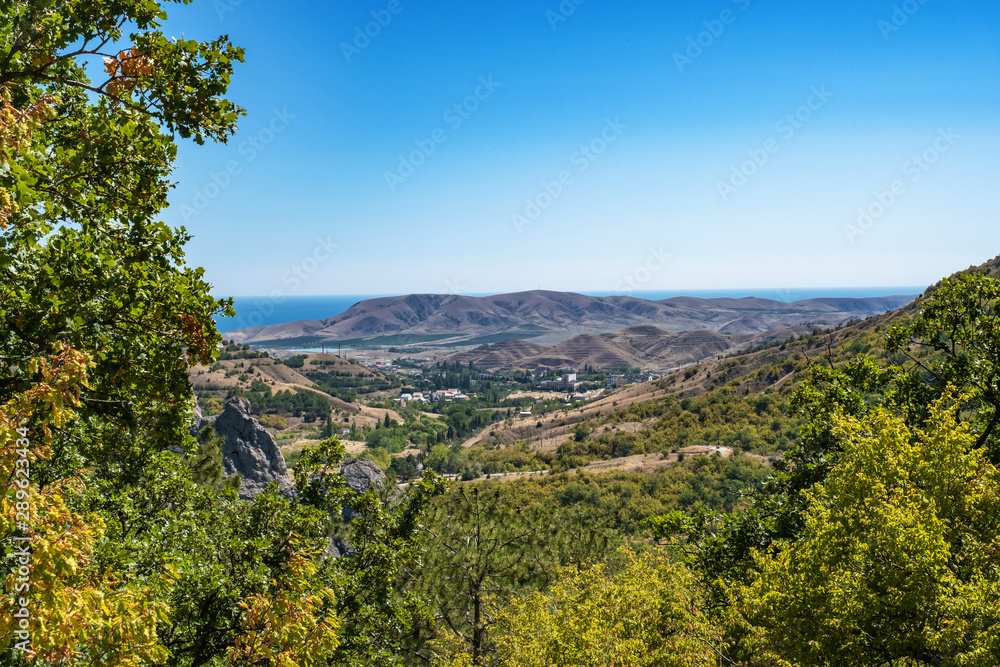 Summer Crimean landscape with mountains and the sea on a sunny day.