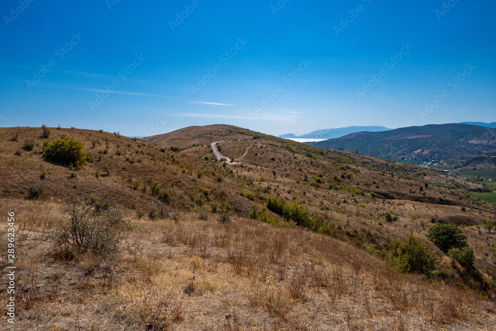 Summer Crimean landscape with mountains and the sea on a sunny day.