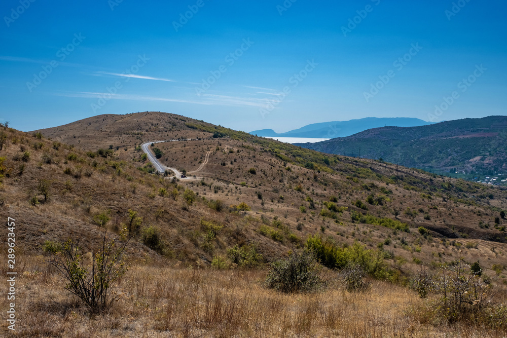 Summer Crimean landscape with mountains and the sea on a sunny day.