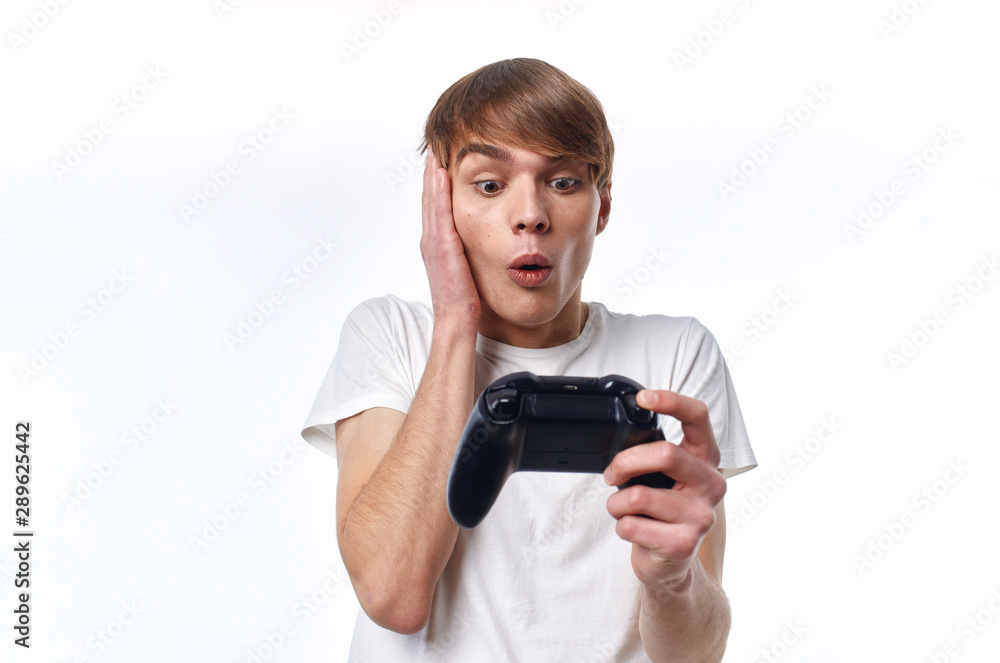 young man with joystick playing video games young man with joystick playing video games