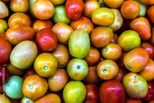 Close up Background of Fresh colorful Tomato and No pesticide residue in The organic market.